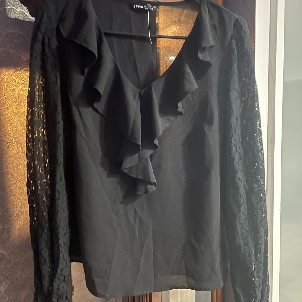 Black blouse with low front beautiful sleeves with elastic end of sleeves